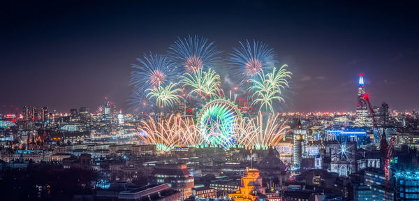 High angle view of firework display at night