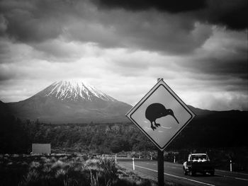 Road by mountain against sky