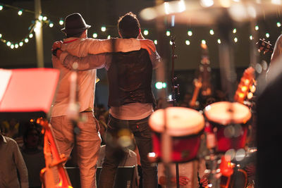 Rear view of men at music concert