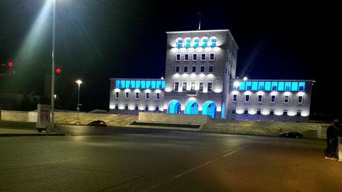 Illuminated building against sky at night