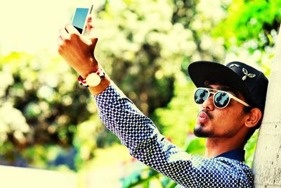 Young man taking selfie with mobile phone
