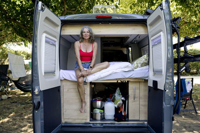 Senior woman sitting in camper van