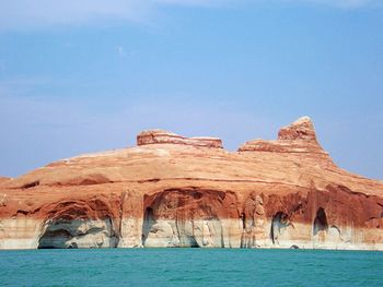 Scenic view of lake powell and rock formations against clear blue sky