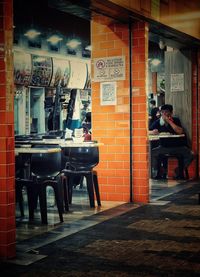 Chairs and tables in illuminated restaurant