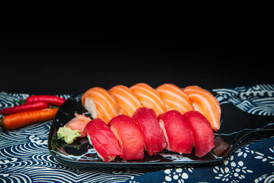 Close-up of dessert in plate against black background