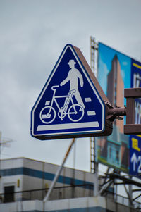 Close-up of road sign against sky