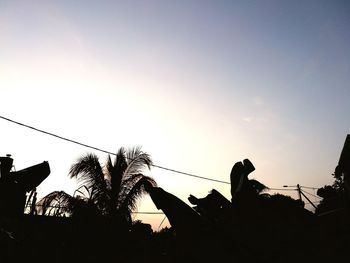 Low angle view of silhouette trees against sky at sunset