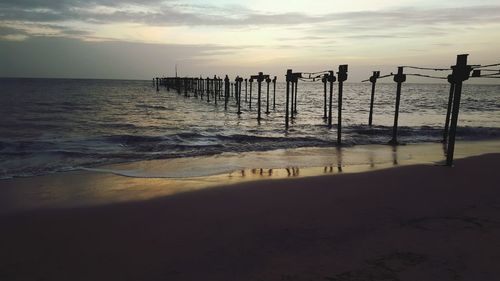 Scenic view of beach against sky during sunset