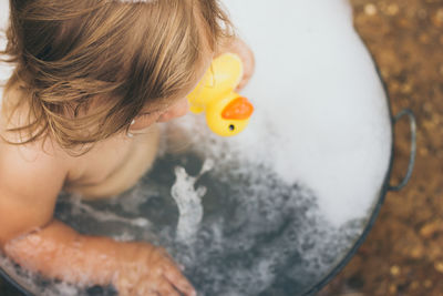 High angle view of baby girl in bathtub