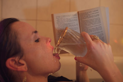 Portrait of woman drinking water from glass