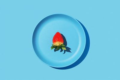 Close-up of fruits against blue background