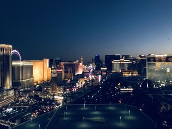 High angle view of illuminated buildings against sky at night