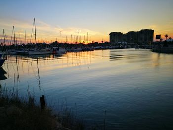 Scenic view of harbor against sky during sunset