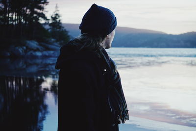 Man looking at lake during sunset