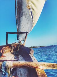 Boat in sea against clear blue sky