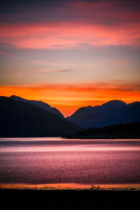 Scenic view of mountains against orange sky