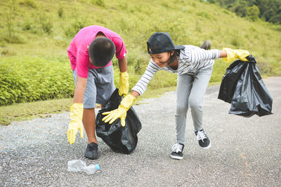 Volunteers collecting garbage on road