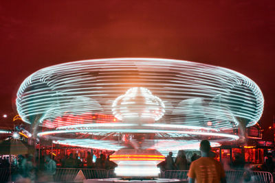 Illuminated ferris wheel at night