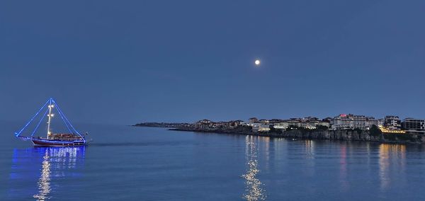 Scenic view of sea against clear sky at night