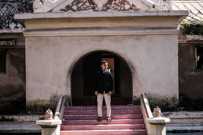 Man standing at historical building