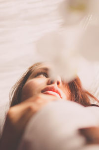 Low angle view of young woman looking away