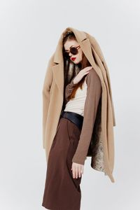 Portrait of woman standing against white background