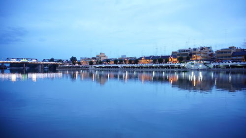 Reflection of buildings in river against sky