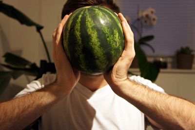 Close-up of man holding food at home