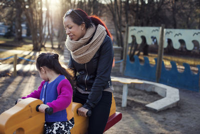 Mother with daughter on rocking horse