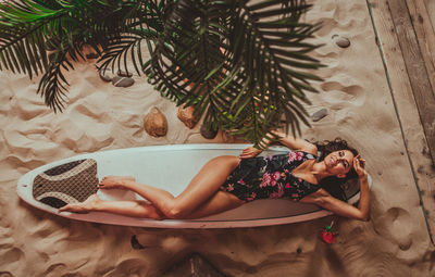 High angle view of woman relaxing on plant