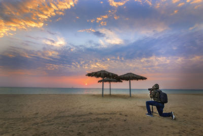 Scenic view of beach against sky during sunset