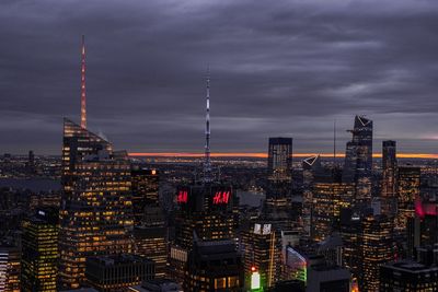 Illuminated buildings in city at dusk