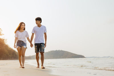 Full length of couple on beach