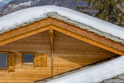 Low angle view of building covered with snow