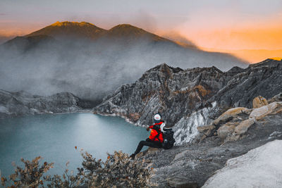 Scenic view of sea against mountain during sunset