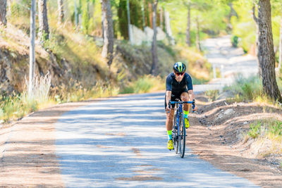 Man riding bicycle on road