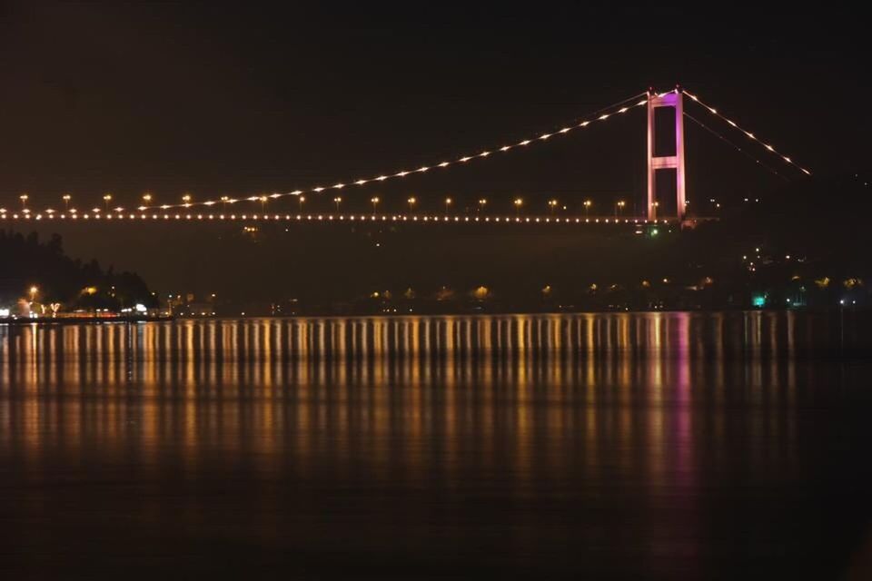 illuminated, night, water, reflection, waterfront, connection, bridge - man made structure, architecture, built structure, river, bridge, clear sky, engineering, sky, no people, outdoors, light, tranquil scene, tranquility, sea