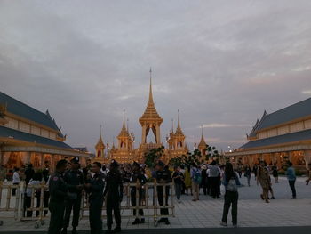 People at temple against sky