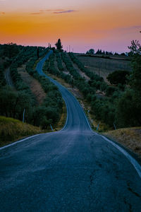 Road amidst landscape against sky during sunset