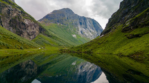 Scenic view of lake and mountains against sky