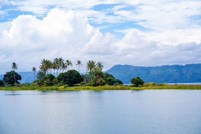 Scenic view of the lake against the mountain and the cloudy sky