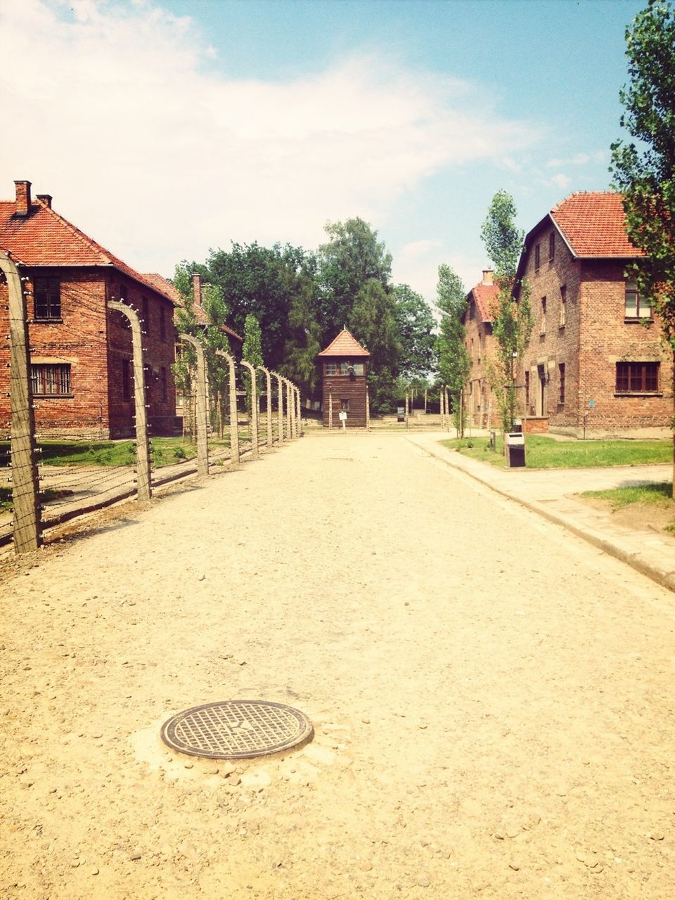 building exterior, architecture, built structure, house, sky, residential structure, tree, residential building, the way forward, street, building, day, cloud - sky, outdoors, cobblestone, grass, cloud, diminishing perspective, road, city