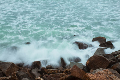 Waves breaking on rocks at shore