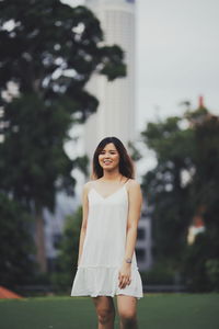 Portrait of a smiling young woman standing outdoors