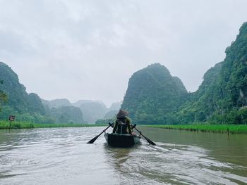 Man rowing boat in lake