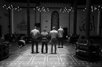 Men standing in illuminated lights