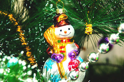 Close-up of christmas decorations hanging on tree