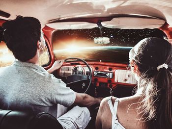 Rear view of people sitting in car