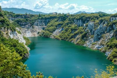 Scenic view of lake and mountains against sky