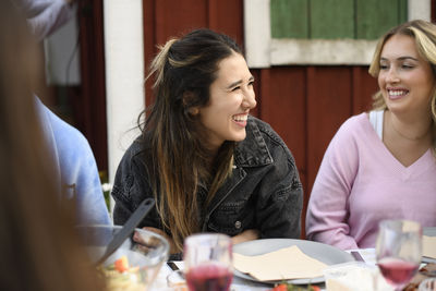 Young woman using mobile phone at restaurant